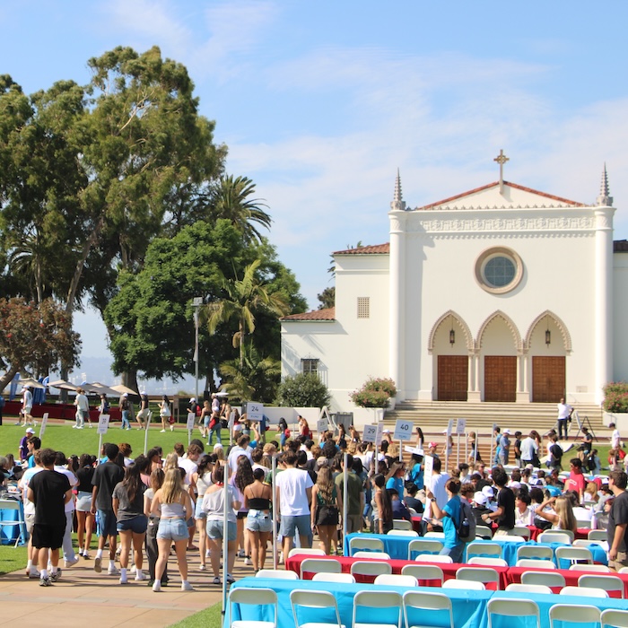 Multiple students at an Orientation Event in front of the LMU chapel